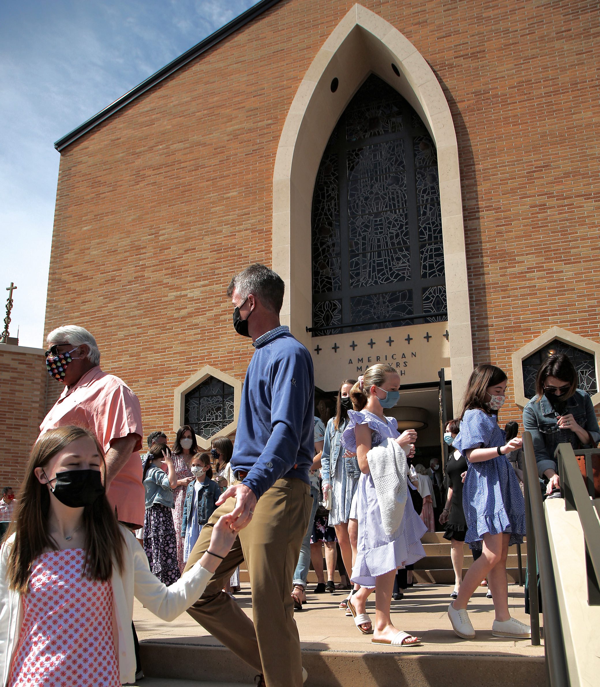 Exterior shot of the congregation leaving the American Martyrs Church, a Southern California Religious Architecture Project by Pica + Sullivan Architects.