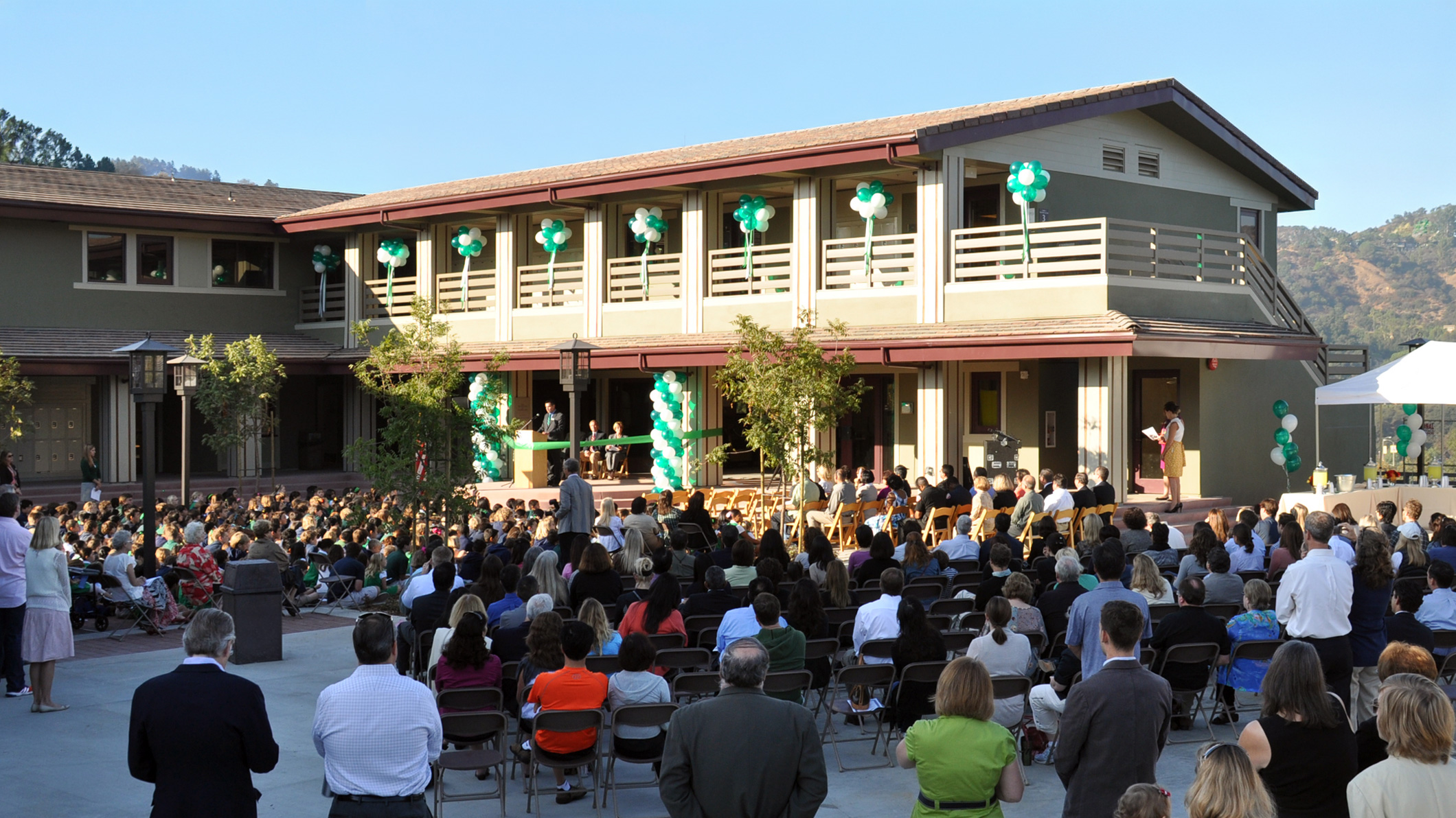 A large crowd sits for an opening ceremony at the Chandler School in Pasadena, an educational architecture project in Southern California.