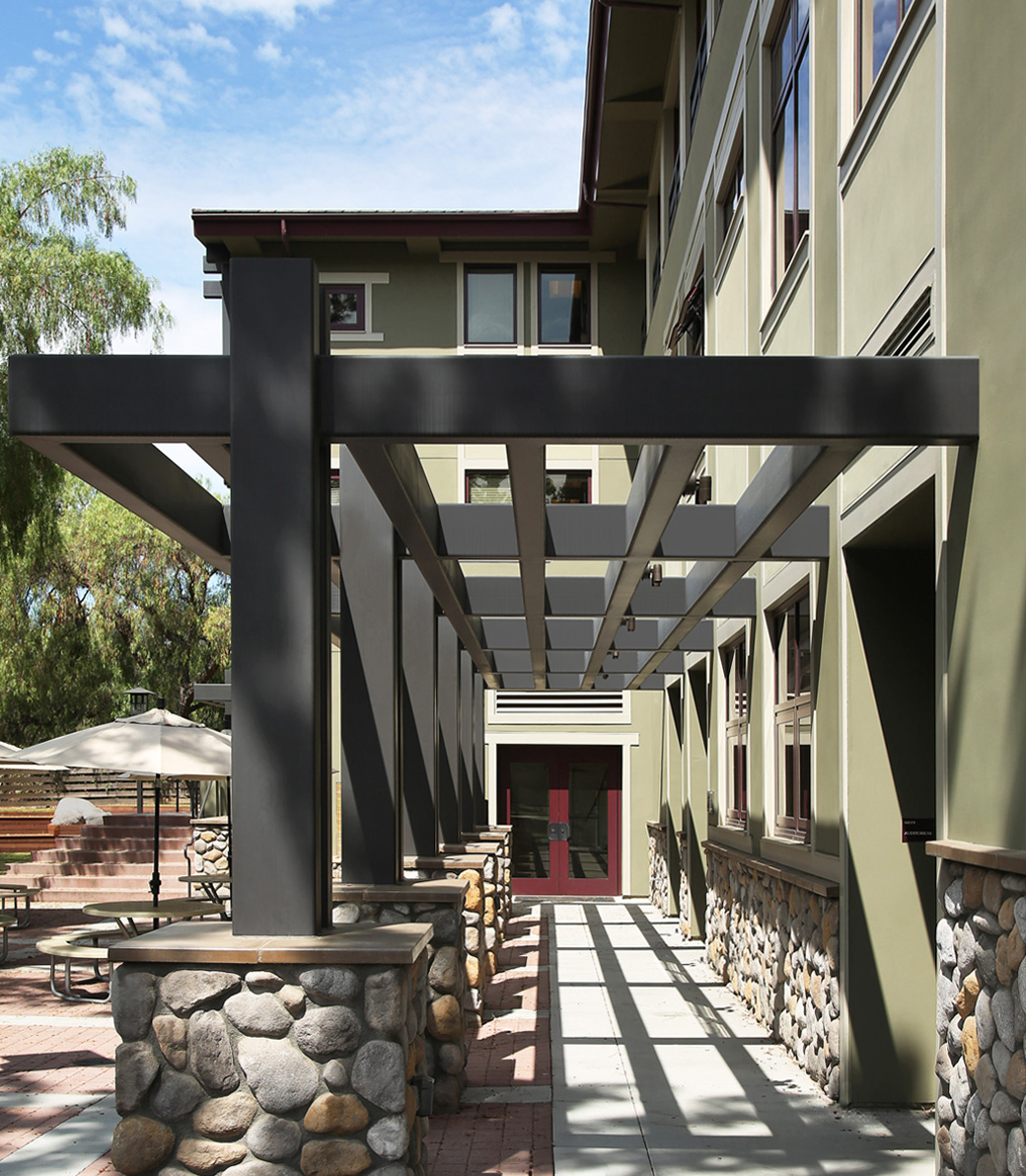 An exterior hallway at the Chandler School in Pasadena, an educational architecture project in Southern California, with a focus on the beautifully designed trellis.