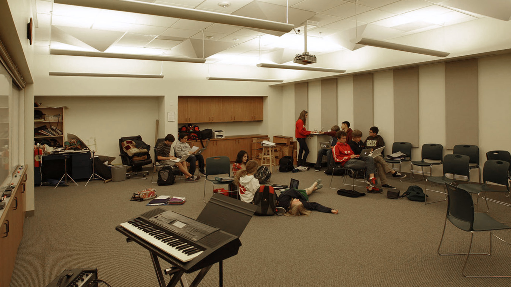 Students work and talk in a room at the Chandler School in Pasadena, an educational architecture project in Southern California.