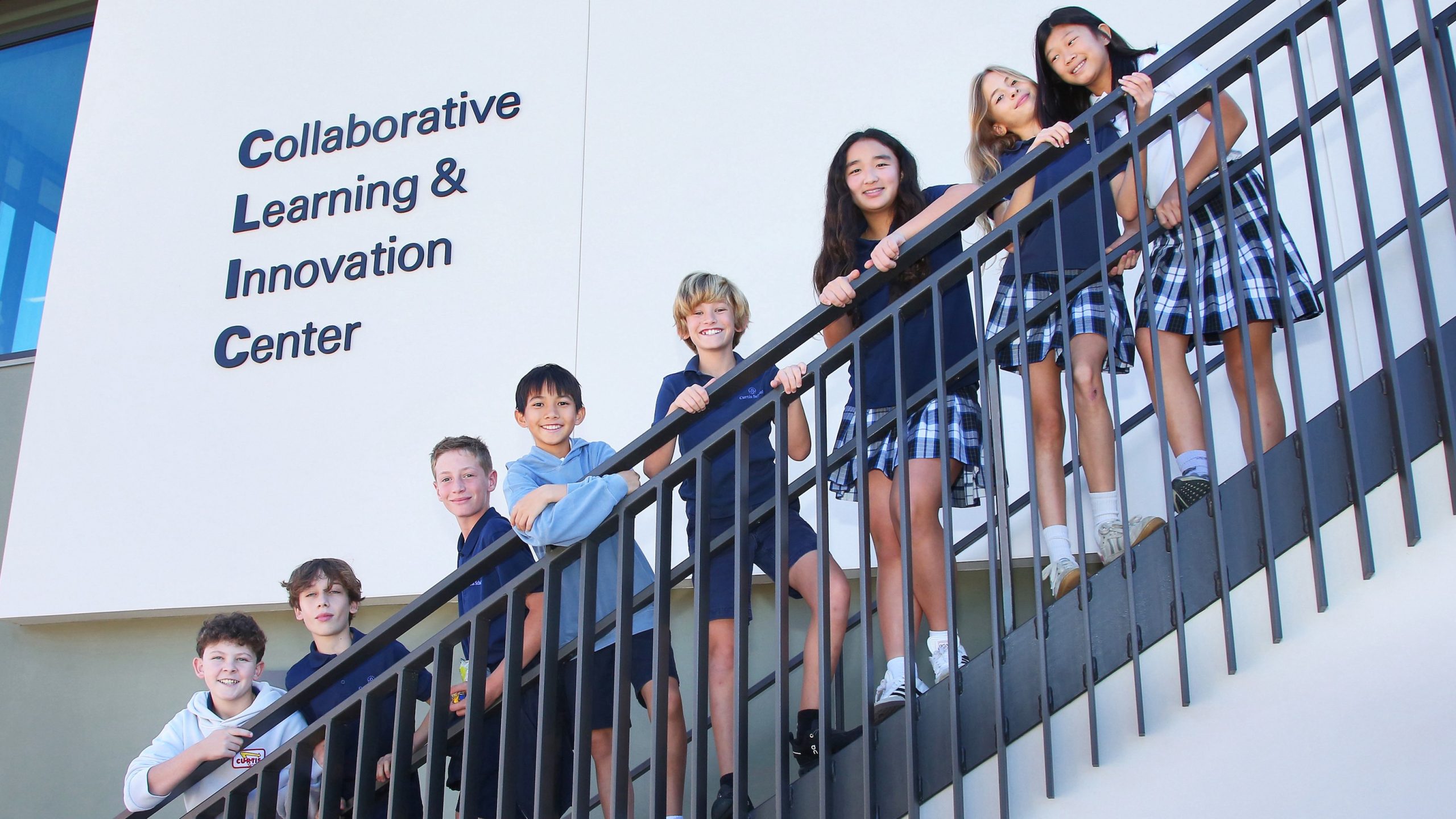Students lined up along an outside staircase at the Collaborative Learning and Innovation Center, a Los Angeles educational architectural project by Pica + Sullivan Architects.