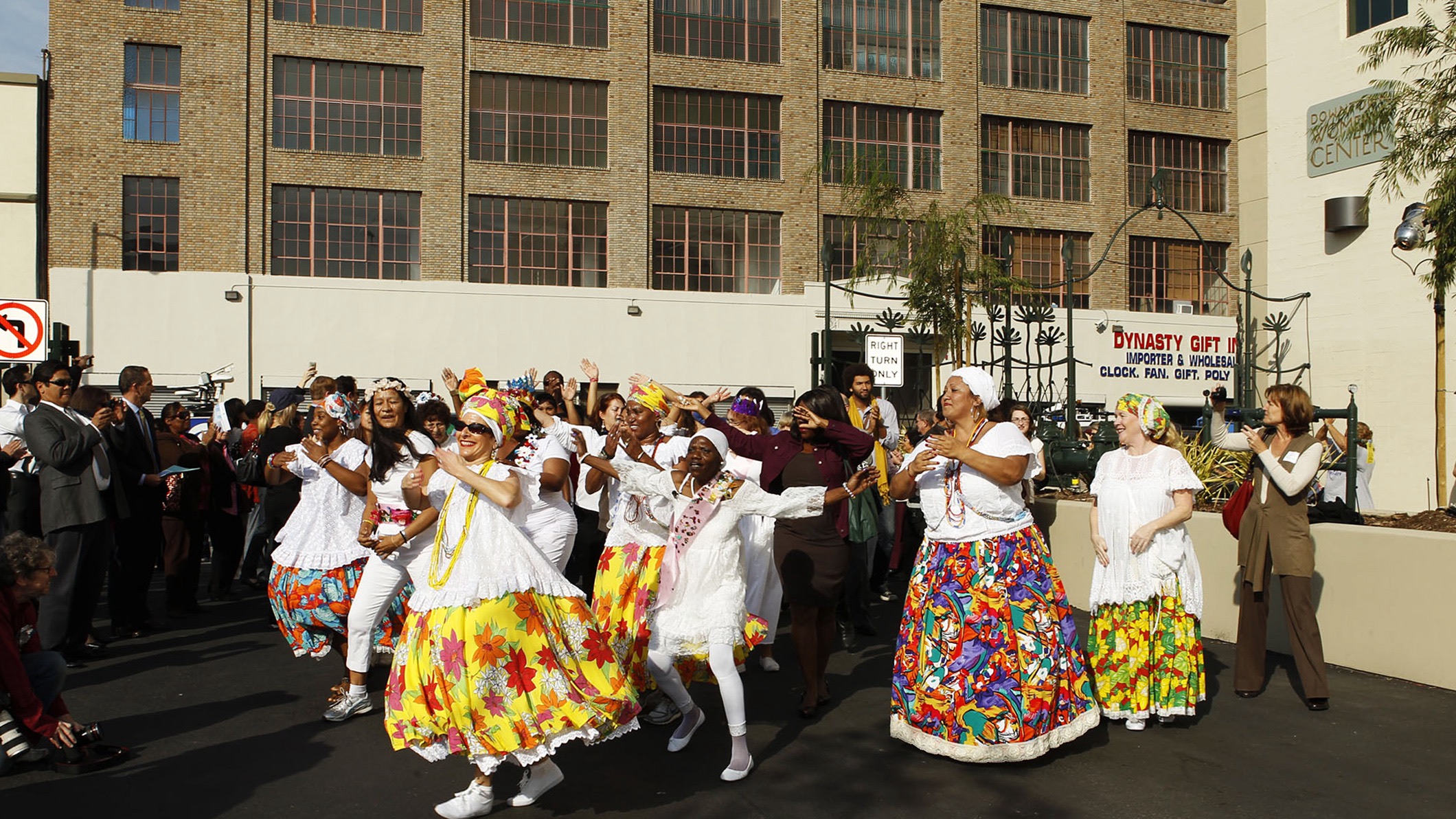 Women dance in costume in front of the Downtown Women's Center in Los Angeles, a Pica+Sullivan Southern California non-profit architectural renovation project.