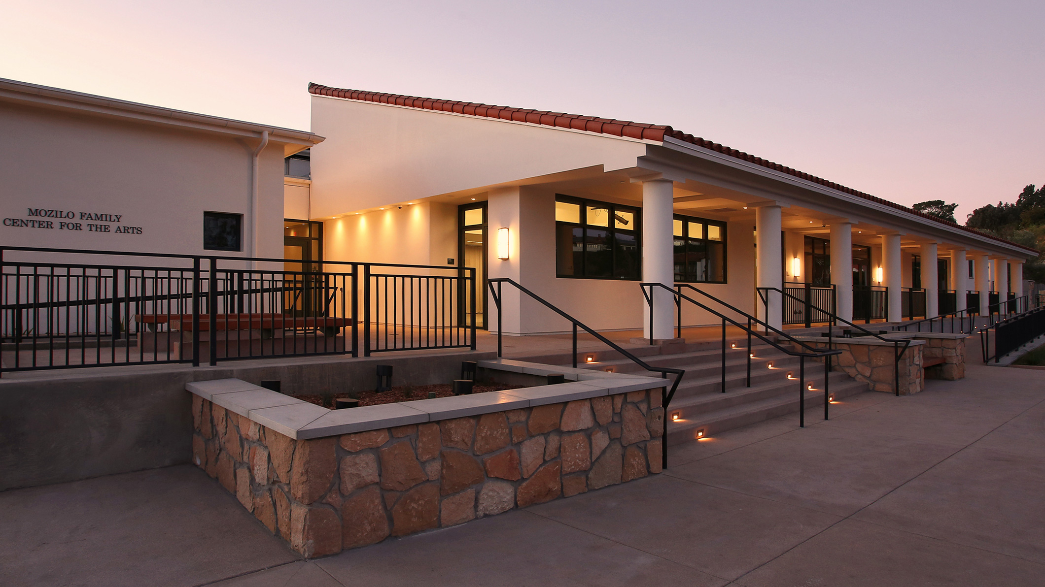 Sunset at the front entrance of the Mozilo Family Center for the Arts at the Flintridge Sacred Arts Academy, an educational architectural project in Southern California.