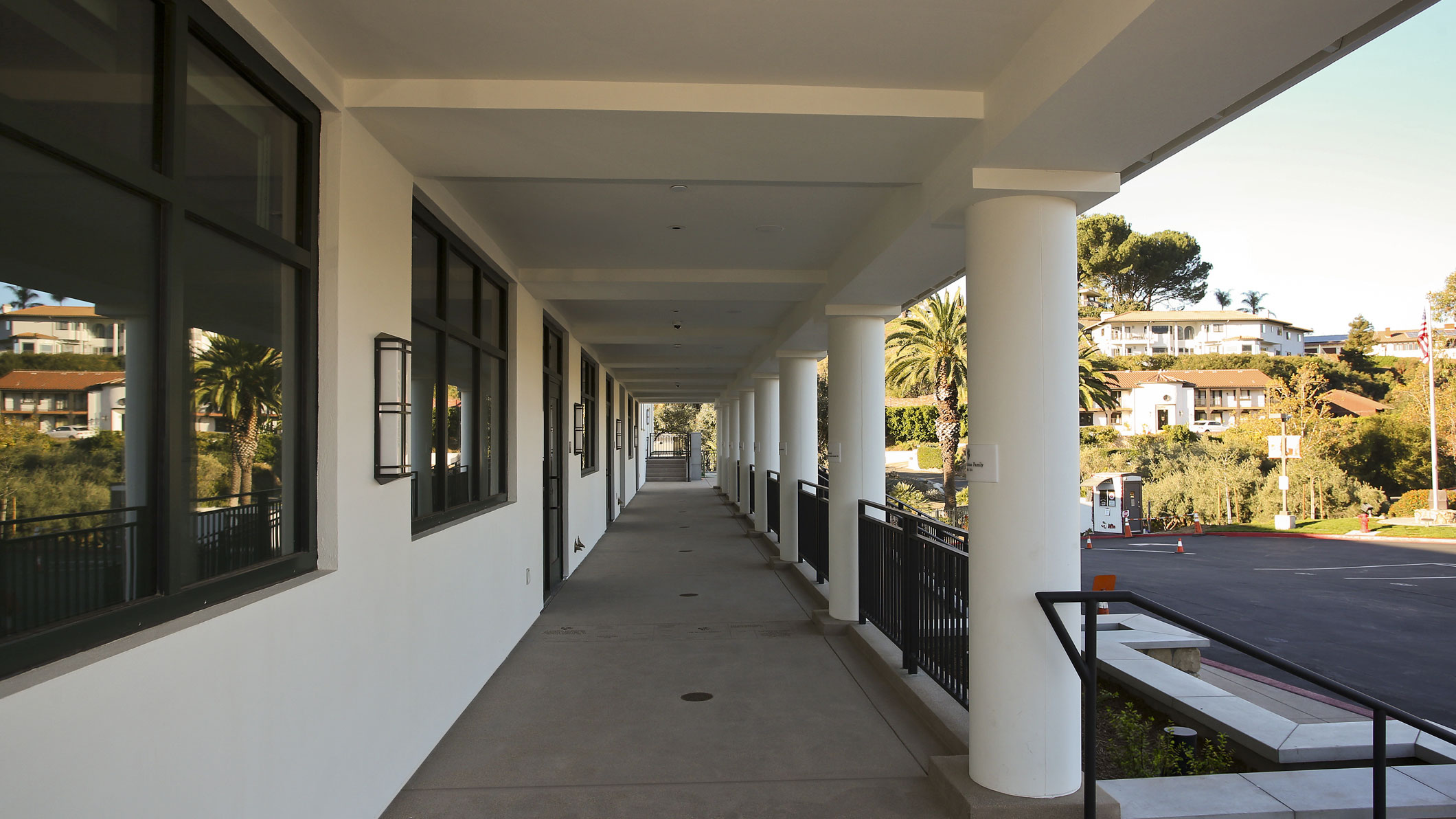 Daytime exterior walkway at the Mozilo Family Center for the Arts at the Flintridge Sacred Arts Academy, an educational architectural project in Southern California.