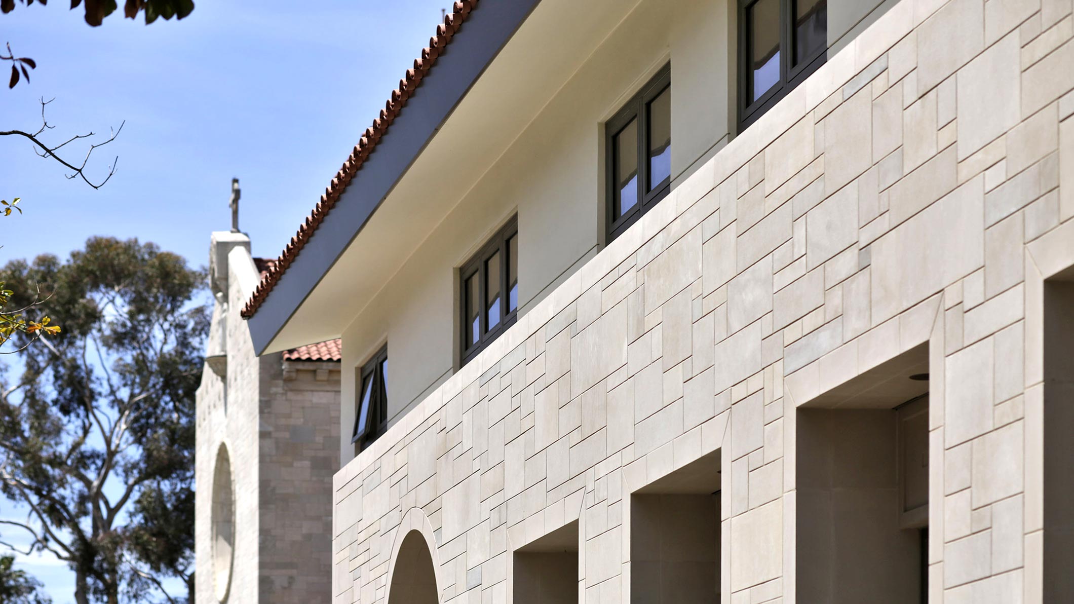 Exterior of the Saint Monica Community Center in Santa Monica, a Pica+Sullivan Southern California educational and religious architectural project, showcasing the second-floor windows.