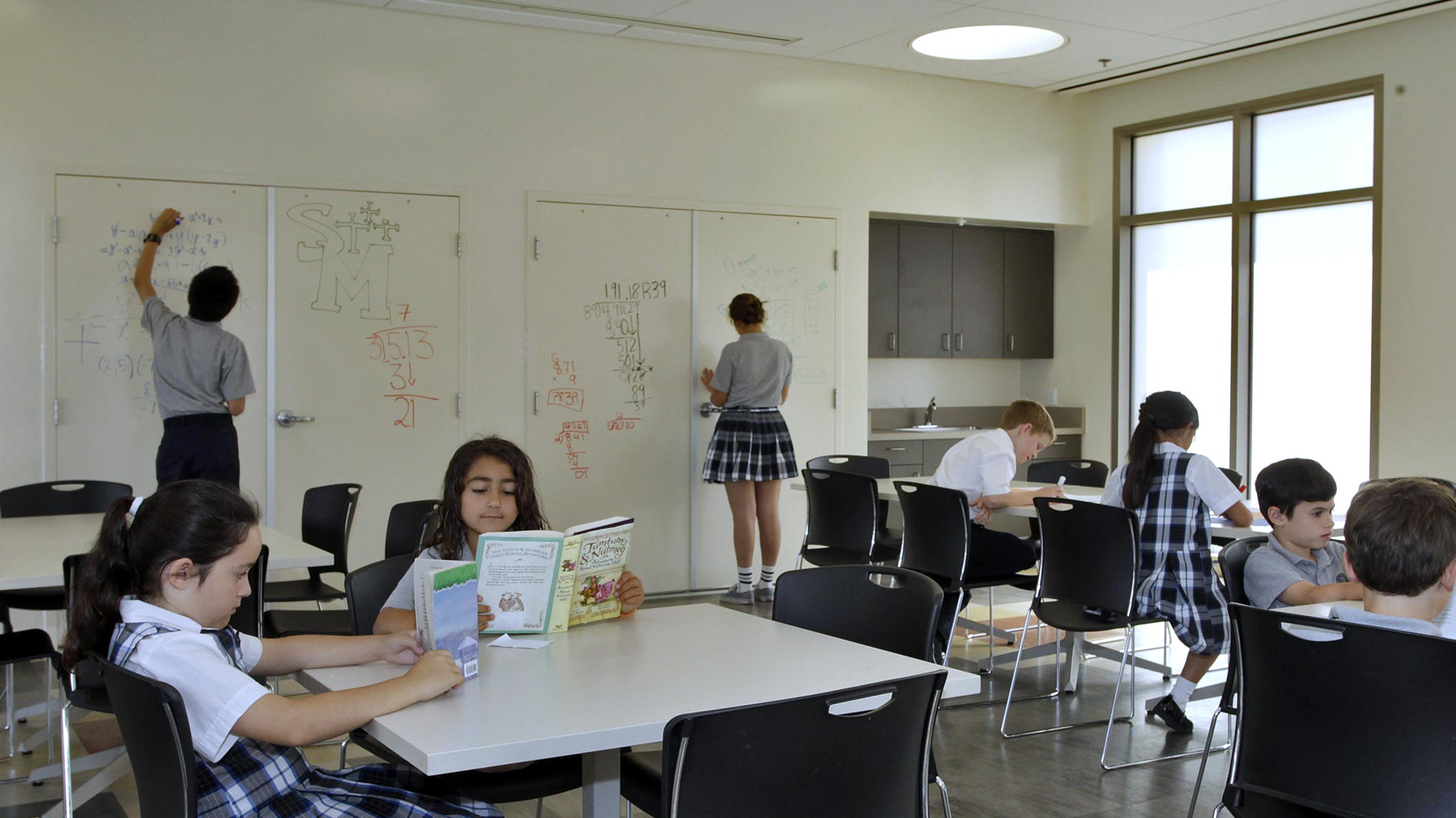 Students work at a classroom at the Saint Monica Community Center in Santa Monica, a Pica+Sullivan Southern California religious and educational architectural project.