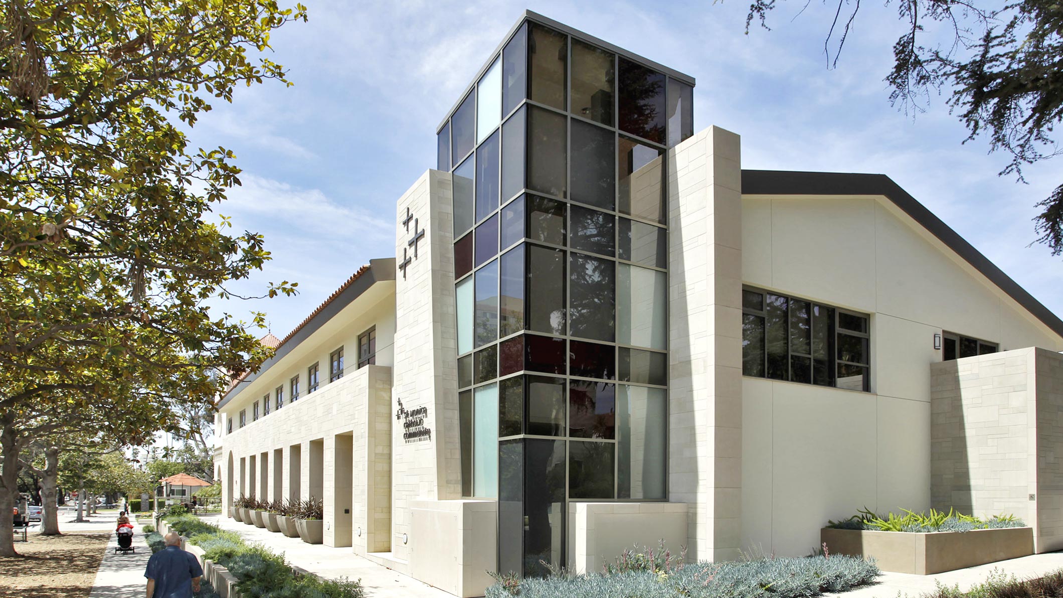 Exterior of a stunning glass-windowed tower at the Saint Monica Community Center in Santa Monica, a Pica+Sullivan Southern California educational and religious architectural project.