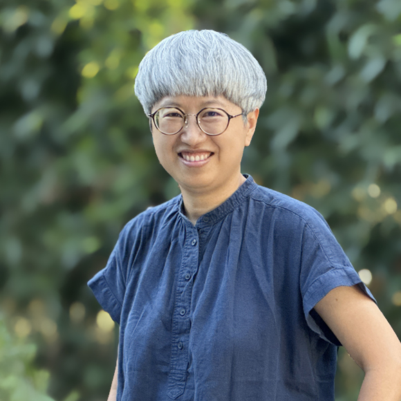 A headshot of Anne Wong, Principal & Director of Architecture of Pica + Sullivan, a Los Angeles-based educational, religious, & non-profit architecture firm.