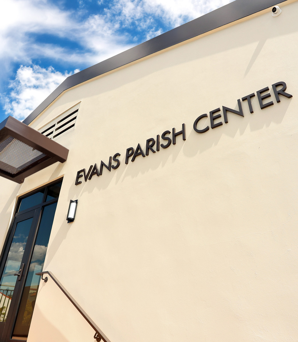 Exterior wall at Holy Family Church Parish Center in Glendale, a Pica+Sullivan Southern California religious architectural project. The words
