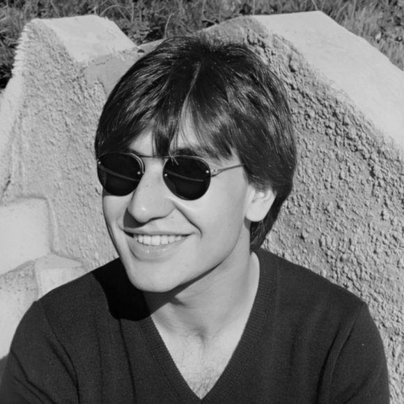 Black-and-white photo of a young Joseph Pica, Founding Principal of Pica + Sullivan, a Los Angeles-based educational, religious, & non-profit architecture firm.