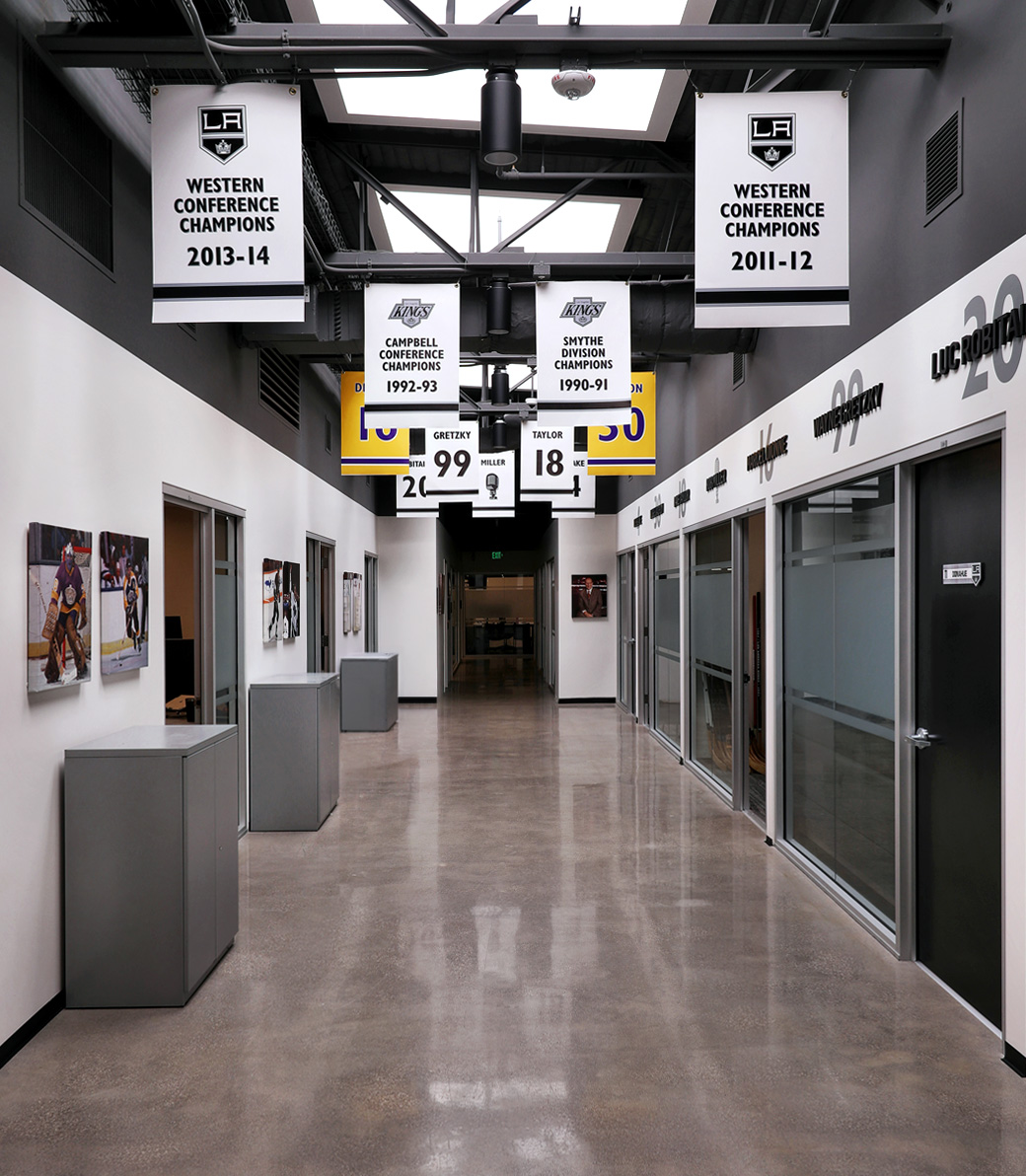 Interior hallway with championship banners at the LA Kings Business Office in El Segundo, a Pica+Sullivan Southern California architectural project.