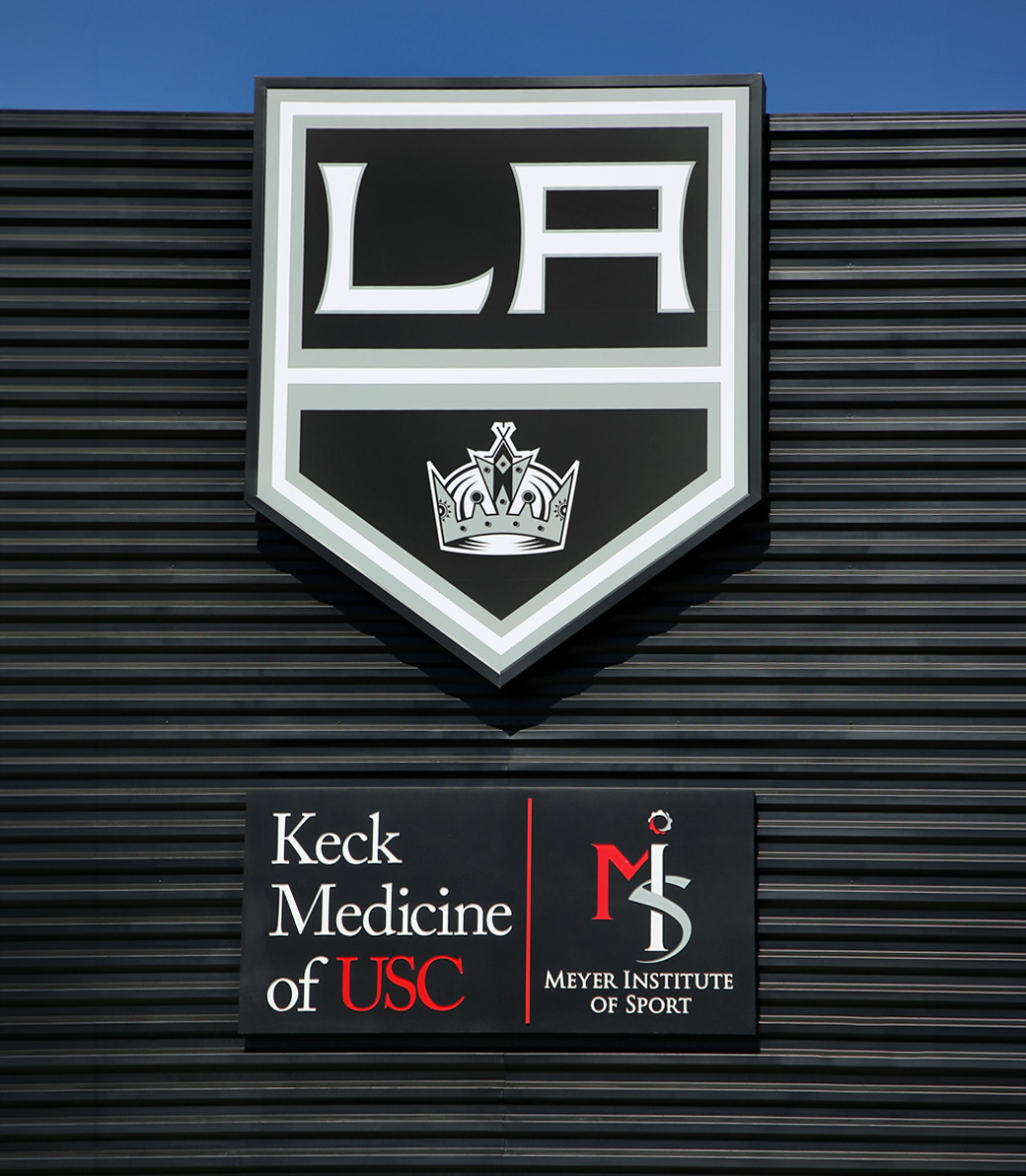 LA-KINGS-USC-019 Outdoor sign at the LA Kings USC Meyer Sports Rehabilitation Center in El Segundo, a Pica+Sullivan Southern California architectural renovation project. The LA Kings Logo over a sign that reads: