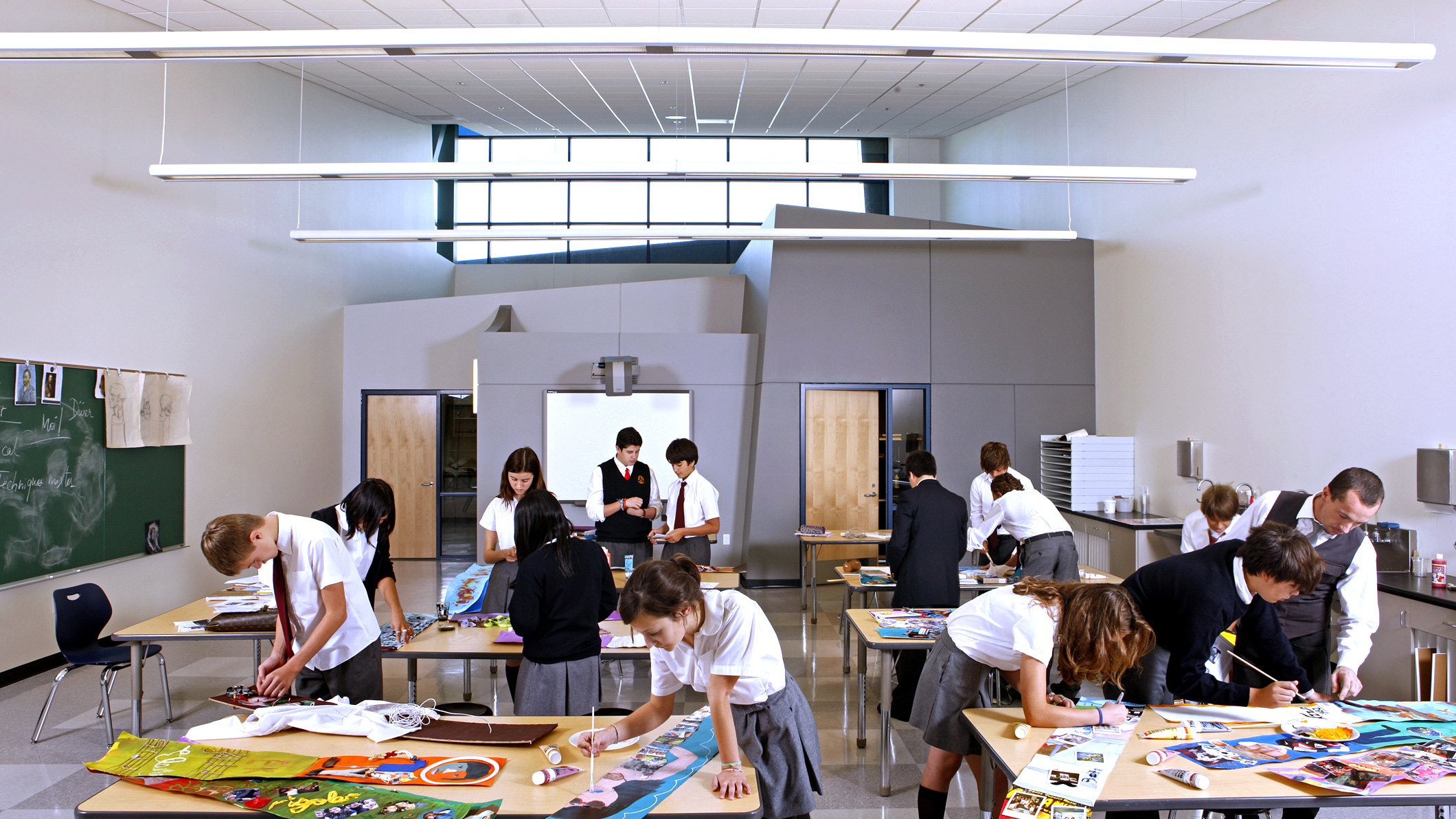 Students work on art projects under a teacher's instruction at Le Français de Los Angeles in Los Angeles, a Pica+Sullivan Southern California educational architectural project.