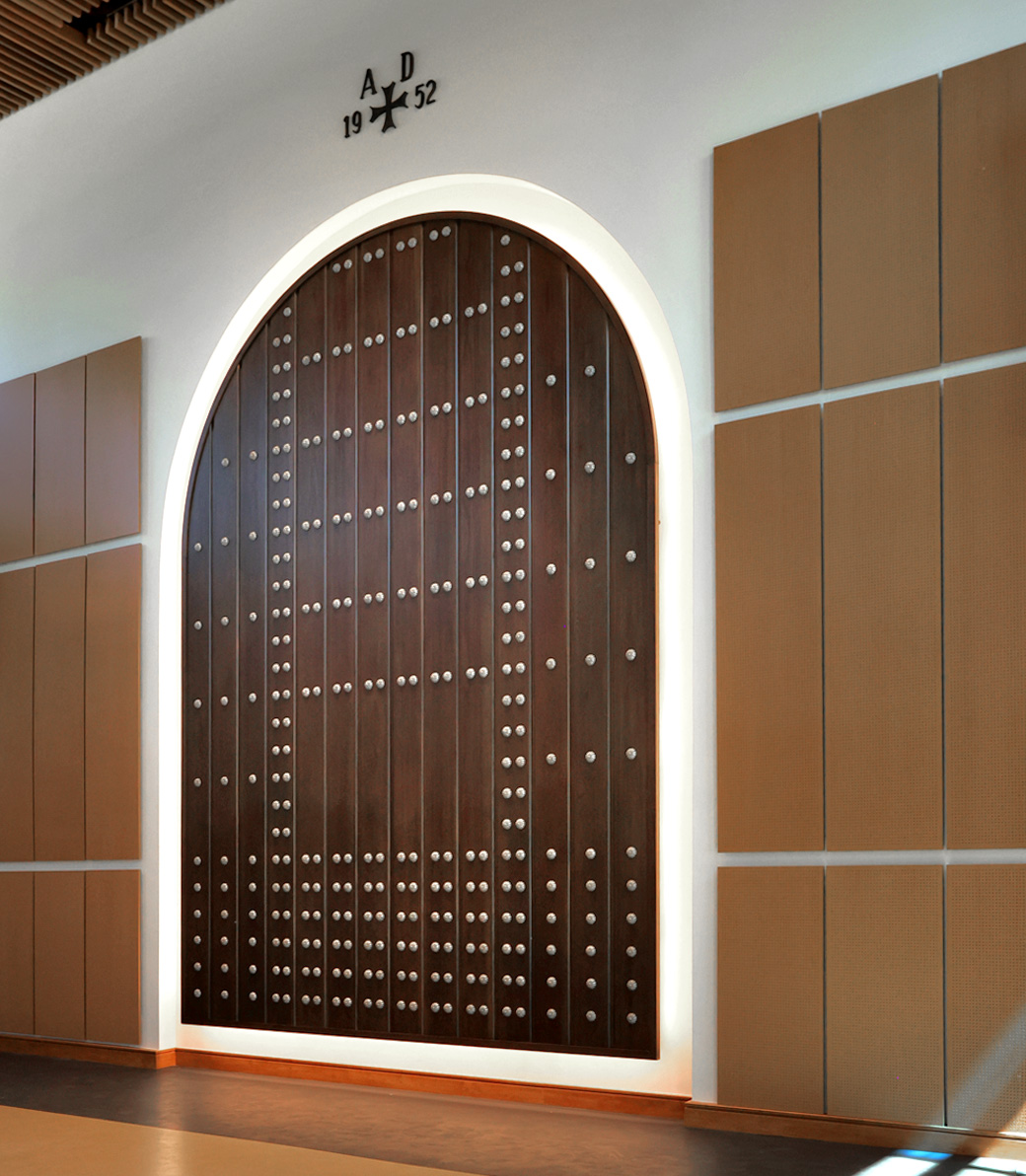 The former church door, now redesigned as a wall decoration honoring the church's history at Saint Bede the Venerable Parish Hall in La Cañada Flintridge, a Pica+Sullivan Southern California religious and educational architectural project.