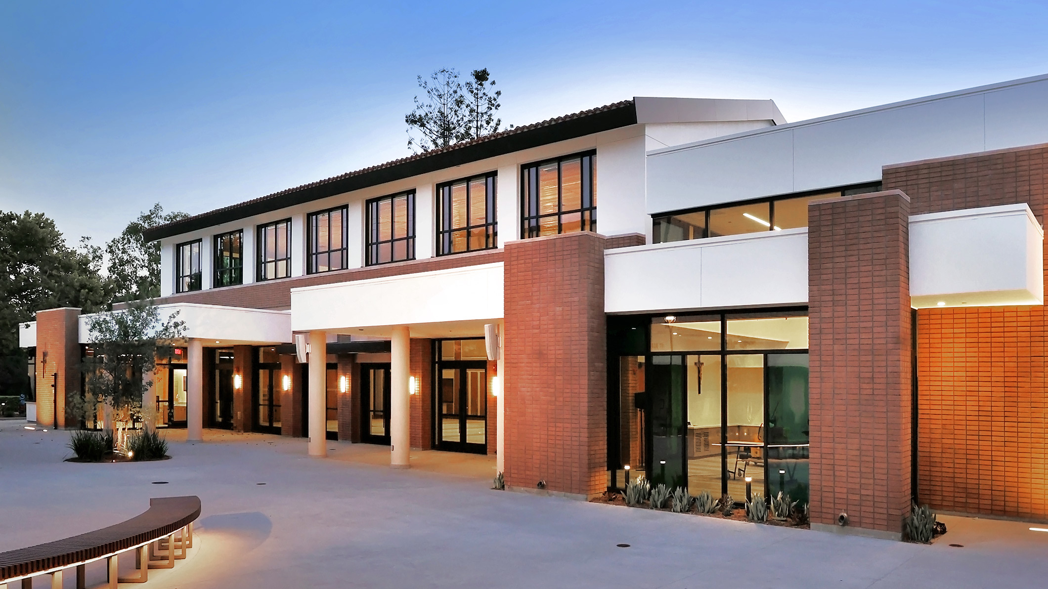 Exterior of Saint Bede the Venerable Parish Hall in La Cañada Flintridge, a Pica+Sullivan Southern California religious and educational architectural project, from a courtyard with benches.