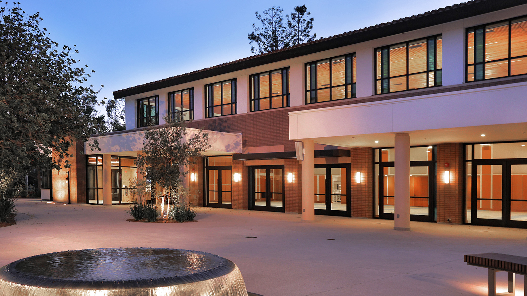 Nighttime exterior of the courtyard, fountain, and side of Saint Bede the Venerable Parish Hall in La Cañada Flintridge, a Pica+Sullivan Southern California religious and educational architectural project.