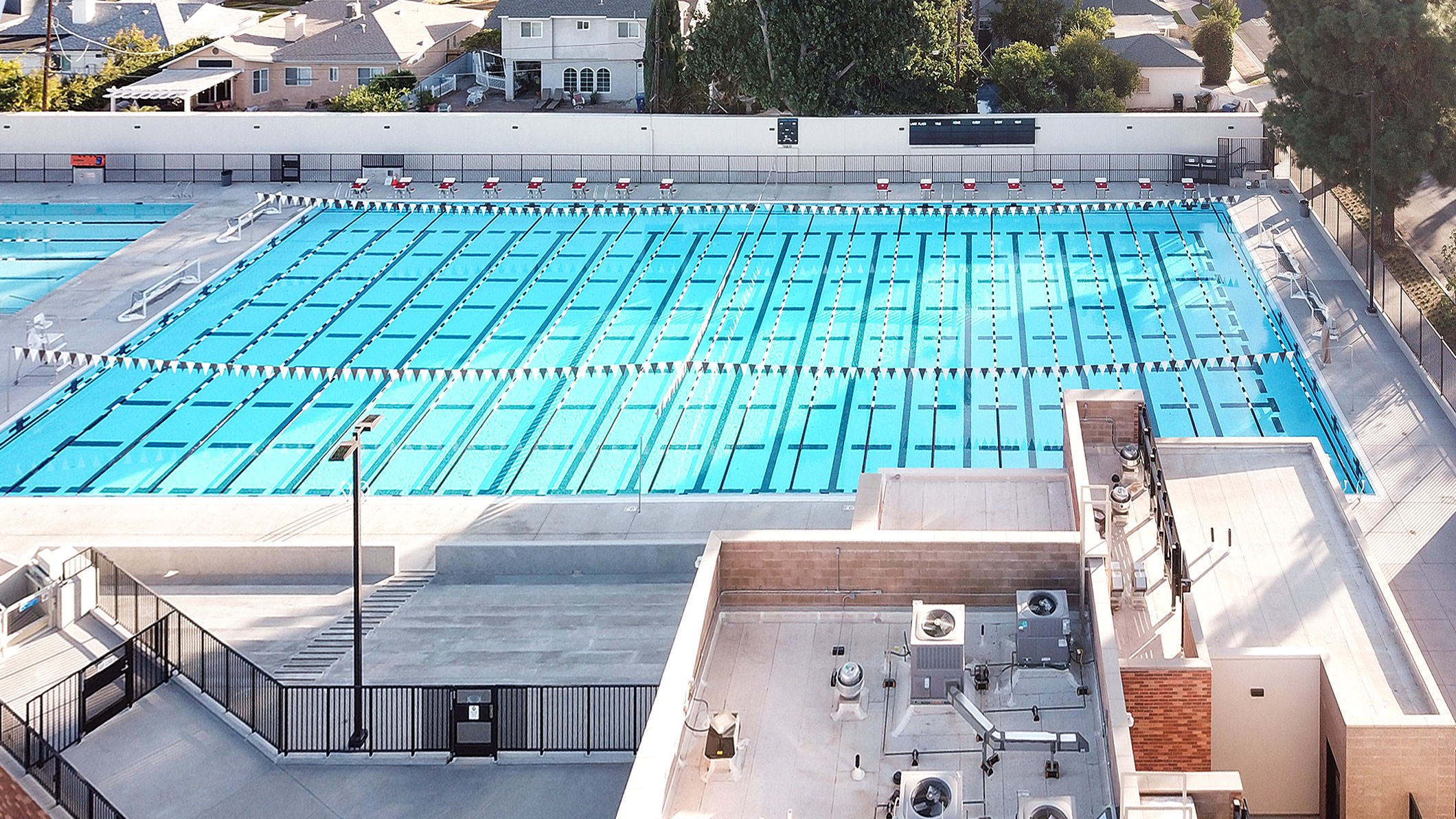 Aerial view of the pool set up for racing at the Robinson Family Aquatics Center at Crespi Carmelite High School in Encino, a Pica+Sullivan Southern California educational architectural project.