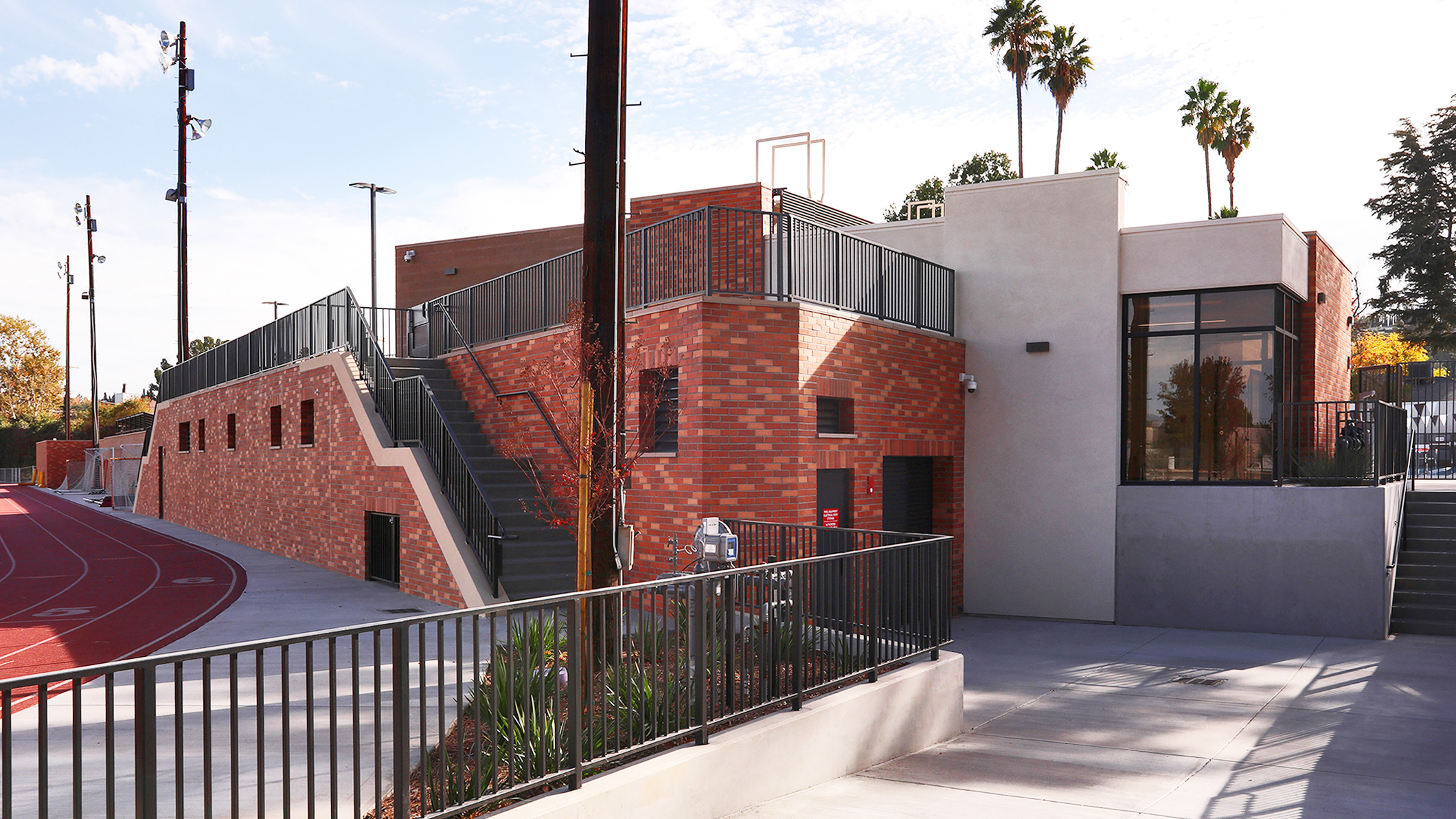 Low-angle view from next to the race track of the elevated Robinson Family Aquatics Center at Crespi Carmelite High School in Encino, a Pica+Sullivan Southern California educational architectural project.