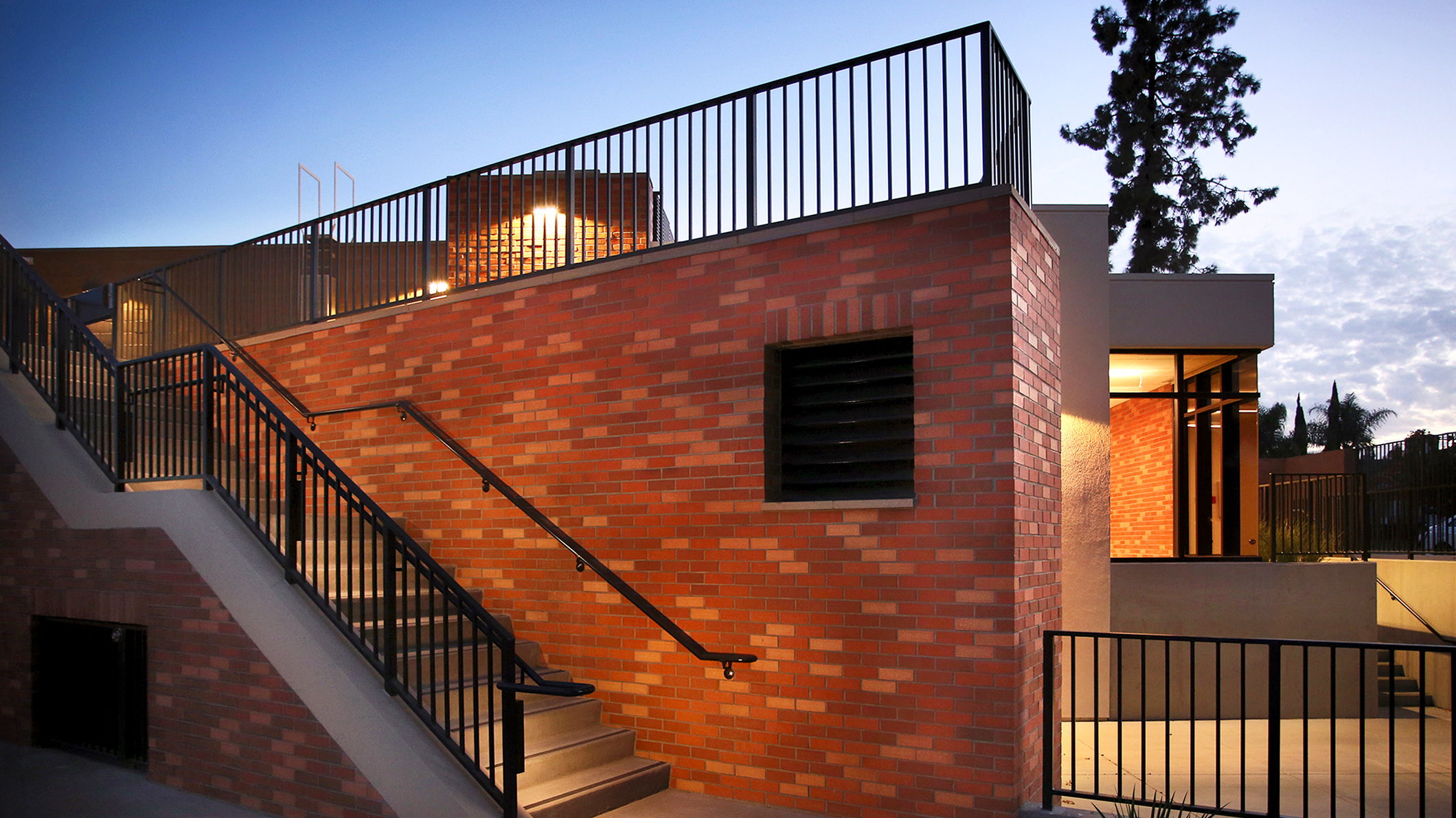 Nighttime exterior view of the staircase at the elevated Robinson Family Aquatics Center at Crespi Carmelite High School in Encino, a Pica+Sullivan Southern California educational architectural project.