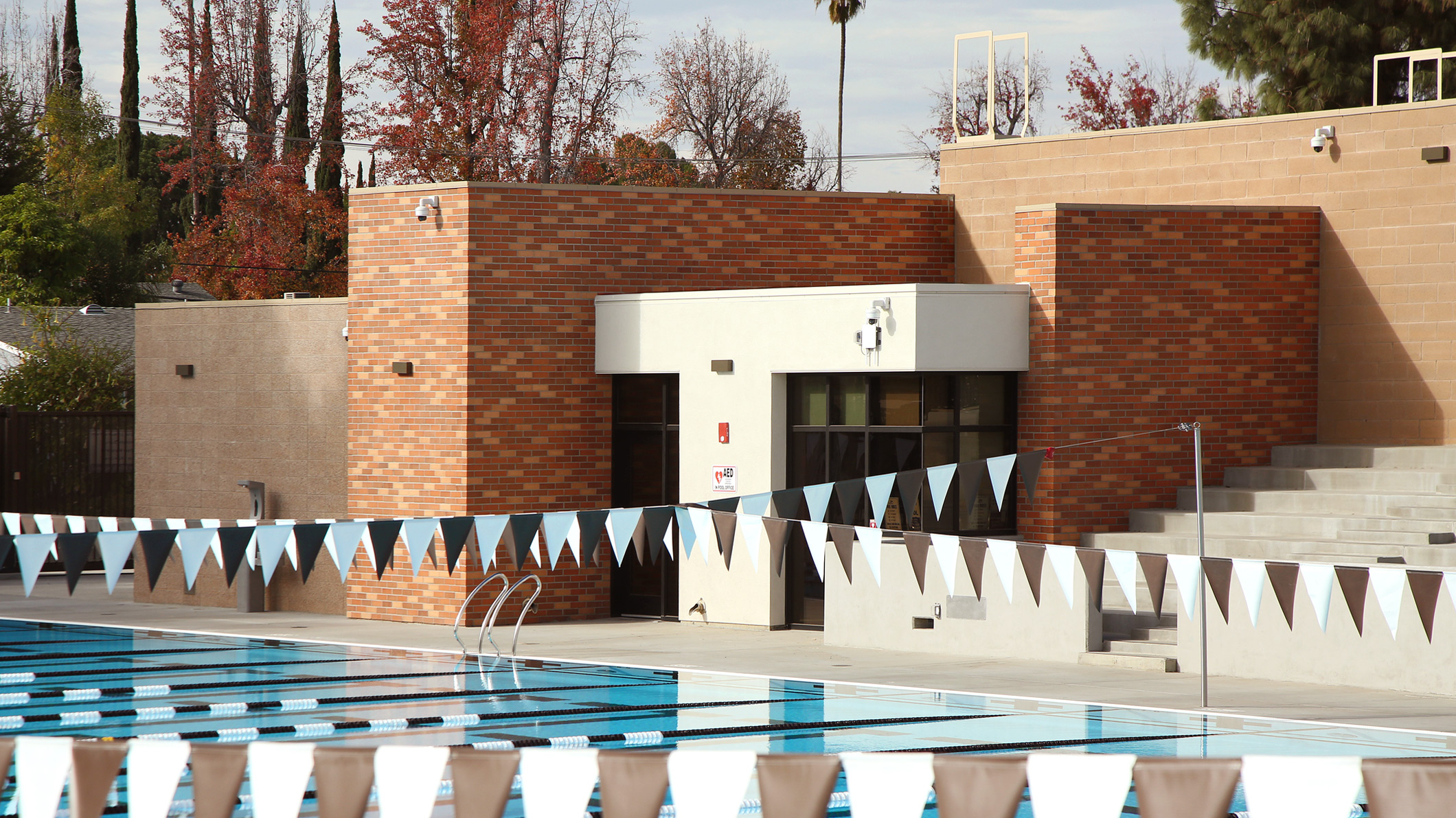 View of bleachers and a pool set up for laps and racing at the Robinson Family Aquatics Center at Crespi Carmelite High School in Encino, a Pica+Sullivan Southern California educational architectural project.