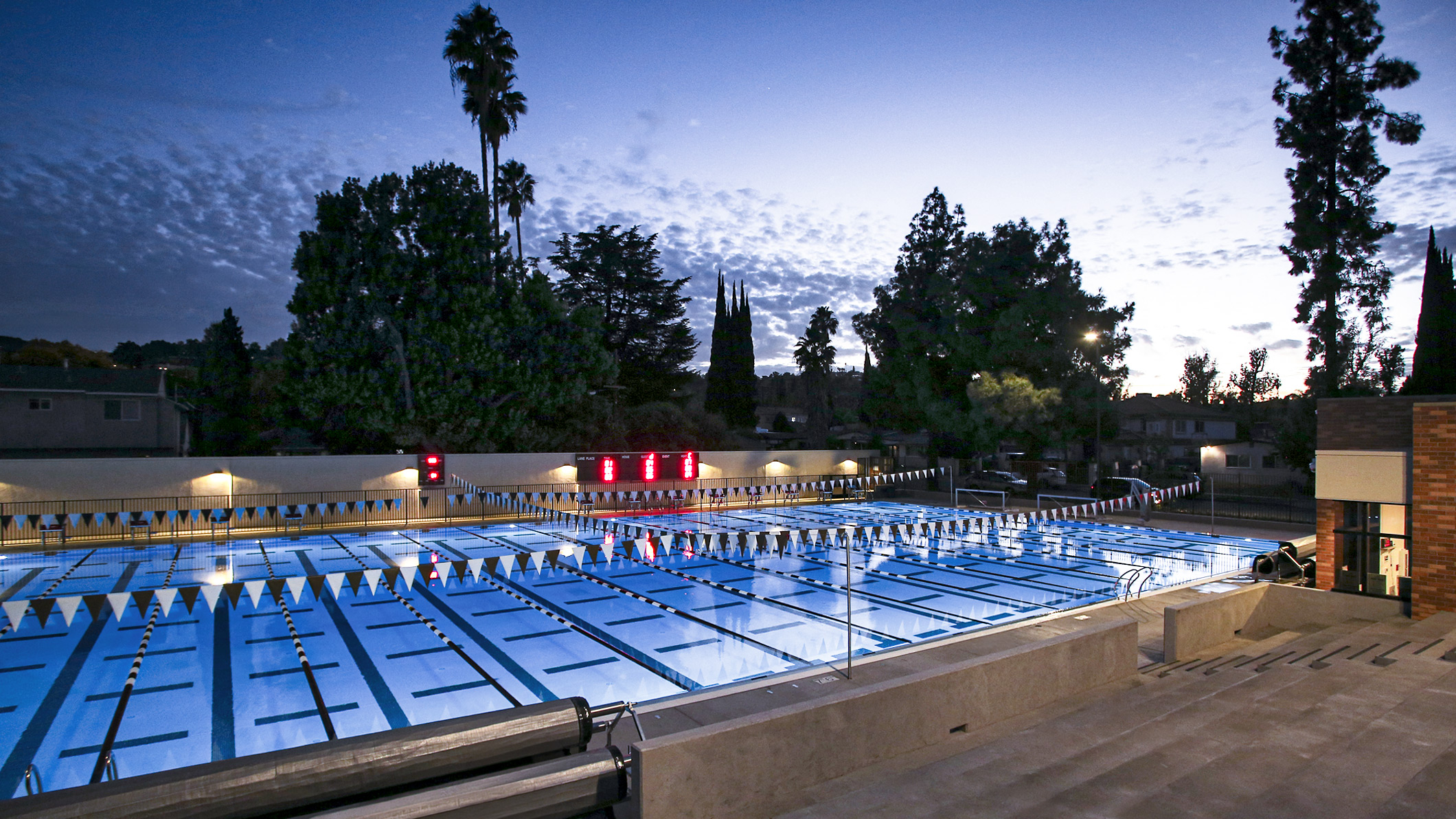 RFA-012 Nighttime view from the bleachers of the pool set up for laps and racing at the Robinson Family Aquatics Center at Crespi Carmelite High School in Encino, a Pica+Sullivan Southern California educational architectural project.
