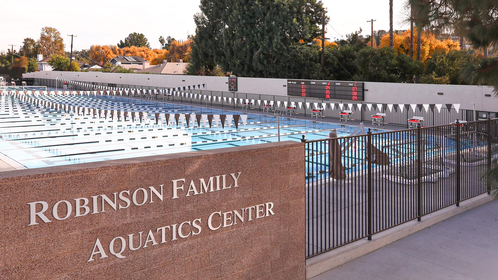 A daytime exterior view from outside the fence of the Robinson Family Aquatics Center of Crespi Carmelite High School in Encino, a Pica+Sullivan Southern California educational architectural project. 