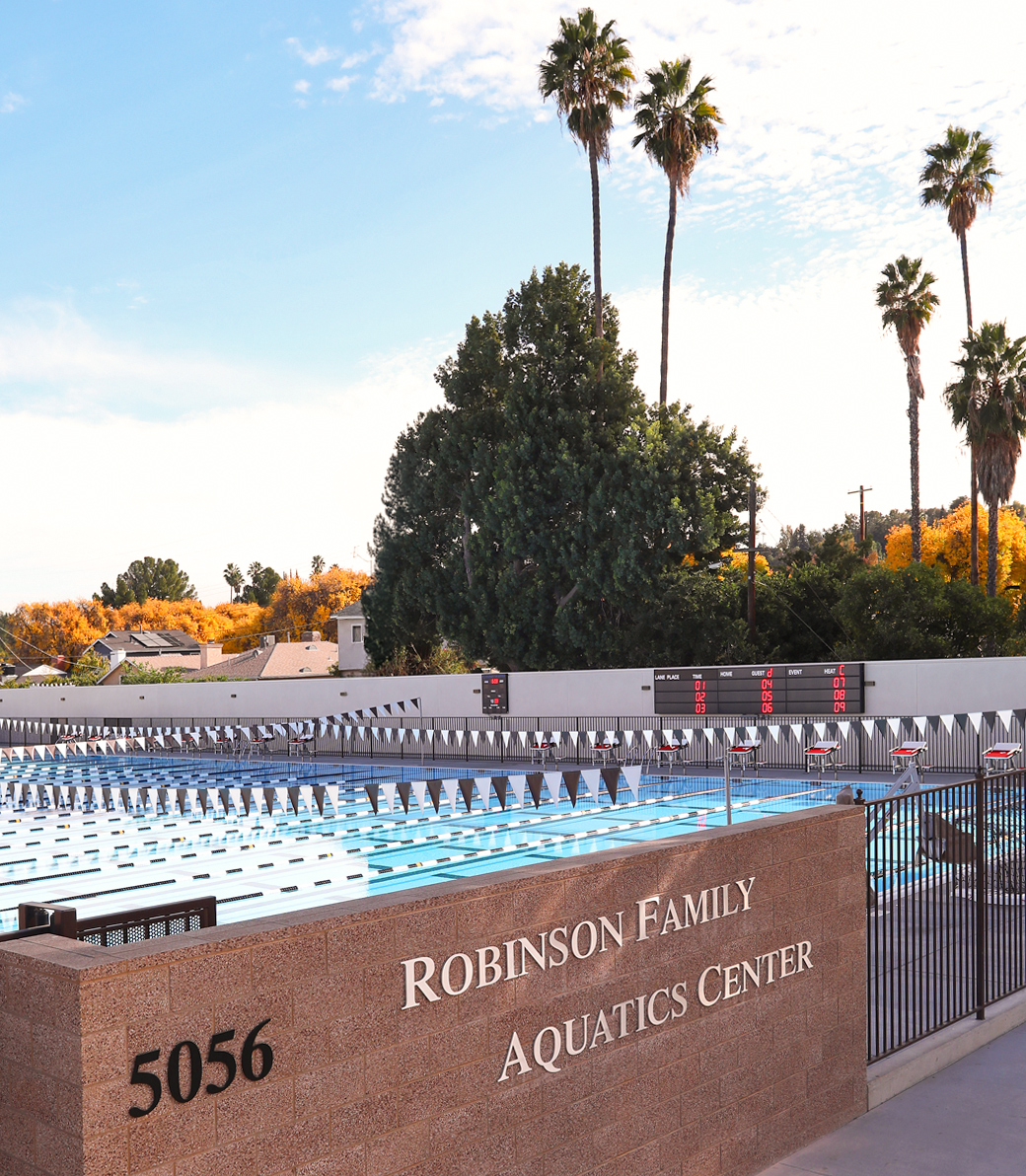 A daytime exterior view from outside the fence of the Robinson Family Aquatics Center of Crespi Carmelite High School in Encino, a Pica+Sullivan Southern California educational architectural project.