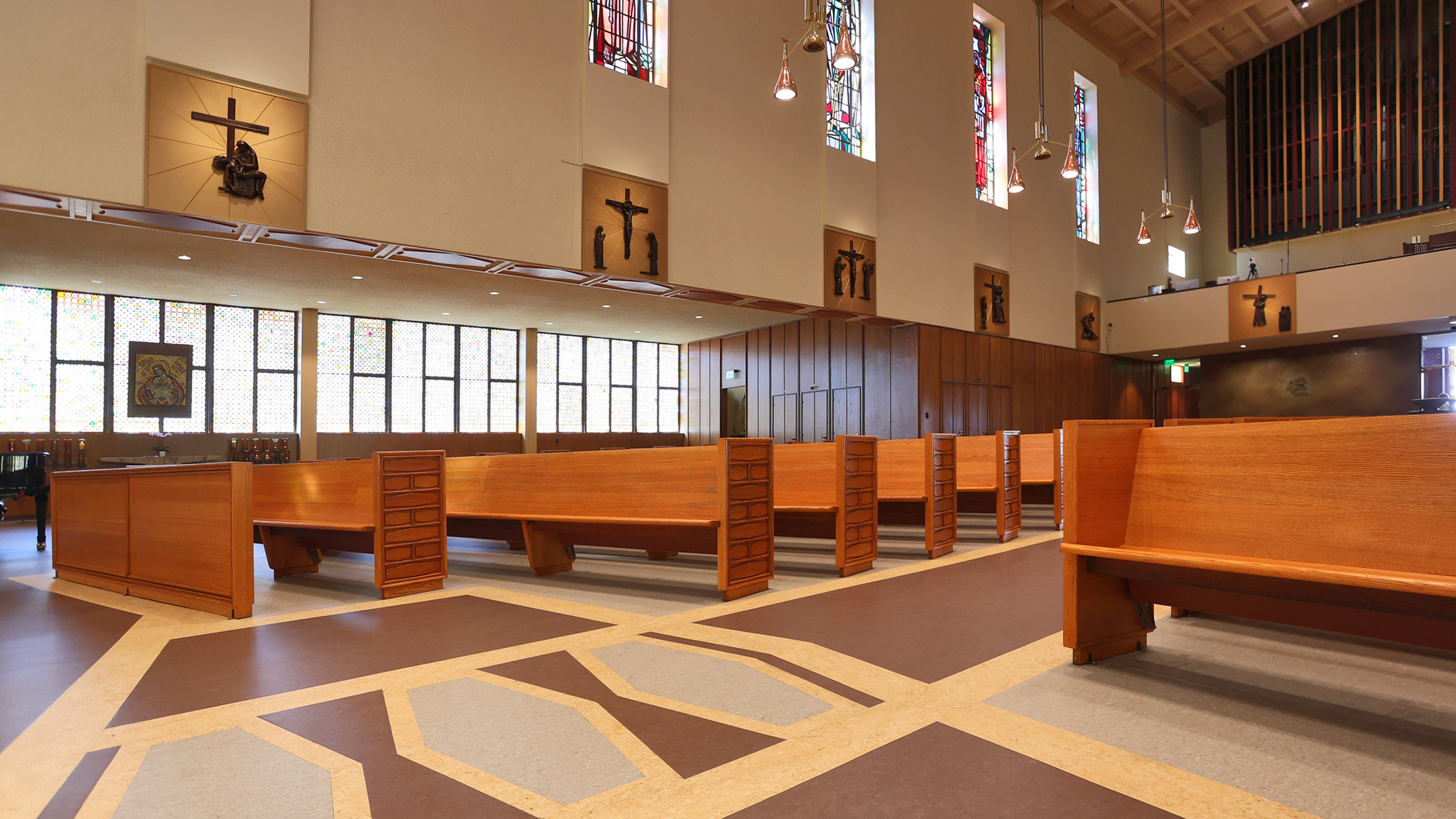 ST-PAUL_008 Empty pews under stained-glass windows at Saint Paul the Apostle Church in Los Angeles, a Pica+Sullivan Southern California religious architectural renovation project.